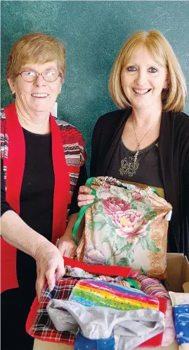  ??  ?? Joining forces to pack up a box of Days for Girls feminine hygiene kits for young nuns in northern India are locals Lorraine Forsyth (left) and Leonie Blackwell.