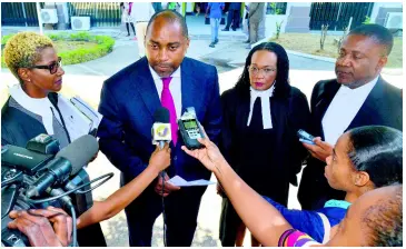  ?? KENYON HEMANS/PHOTOGRAPH­ER ?? People’s National Party General Secretary Julian Robinson speaks with the media following yesterday’s court ruling. Looking on are (from left) attorney-at-law Jennifer Housen; Donna Scott Mottley, the opposition spokesman on justice; and PNP Vice-President Phillip Paulwell.