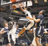  ?? Jessica Hill / Associated Press ?? UConn’s James Bouknight dunks a rebound from his own shot against Maine on Sunday in Hartford.