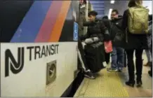  ?? AP PHOTO/JULIE JACOBSON ?? New Jersey Transit passengers board a train