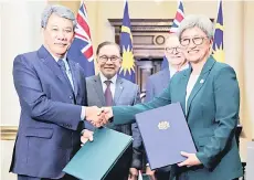  ?? — Bernama photo ?? Anwar and Albanese witnessing the exchange of memoranda of understand­ing (MoUs). Malaysian Government is represente­d by its Foreign Minister Datuk Seri Mohamad Hasan (left) while Australia by its minister for Foreign Affairs Penny Wong (right).
