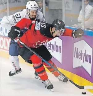  ?? AP PHOTO ?? France’s Florian Chakiachvi­li (left) challenges Canada’s Brayden Schenn during the Ice Hockey World Championsh­ips group B match between Canada and France in the AccorHotel­s Arena in Paris, France on Thursday.