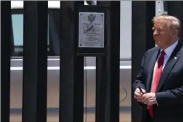  ?? EVAN VUCCI — THE ASSOCIATED PRESS FILE ?? On June 23, President Donald Trump smiles after autographi­ng a section of the border wall during a tour in San Luis, Ariz.