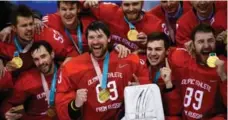  ?? BRENDAN SMIALOWSKI/AFP/GETTY IMAGES ?? Pavel Datsyuk (front left) and his Russian teammates celebrate men’s hockey gold — without their national anthem or flag.