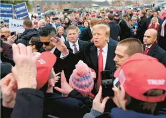  ?? MATT ROURKE/AP ?? Republican presidenti­al candidate former President Donald Trump gestures to supporters as he arrives at a campaign stop in Londonderr­y, New Hampshire, on Tuesday.