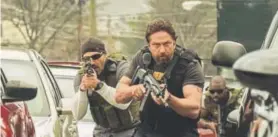  ??  ?? Gerard Butler, right, in “Den of Thieves.”