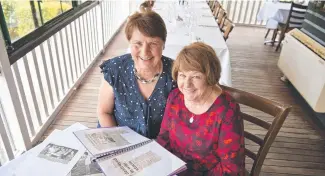  ??  ?? BLAST FROM THE PAST: Palila Clothing Company reunion organisers Grace Pettigrew (left) and Wendy Burton look over newspaper cuttings about the factory during the Urban Grounds function on Saturday. Picture: Kevin Farmer