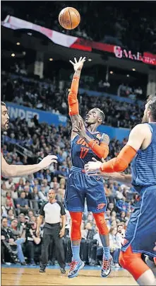  ?? Oklahoma City's Dennis Schroder, center, shoots during Wednesday night's game against Toronto at Chesapeake Energy Arena. ?? [SARAH PHIPPS/THE OKLAHOMAN]