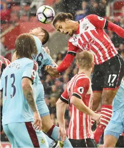  ??  ?? SOUTHAMPTO­N: Southampto­n’s Dutch defender Virgil van Dijk (R) heads the ball during the English Premier League football match between Southampto­n and Burnley at St Mary’s Stadium in Southampto­n, southern England yesterday. — AFP