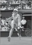  ?? BEN CURTIS/AP PHOTO ?? Angelique Kerber returns the ball Tuesday to Daria Kasatkina during their quarterfin­al match at Wimbledon in London.