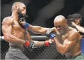  ?? KIERAN CLEEVES AP ?? Champion Leon Edwards (left) takes a shot from Kamaru Usman in their UFC welterweig­ht title bout.