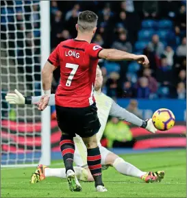  ??  ?? LONG GAME: Shane Long shoots from a tight angle before Kasper Schmeichel’s attempted save diverts the ball into the net for Southampto­n’s second goal