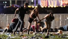  ?? David Becker/Getty Images ?? People run from the Route 91 Harvest country music festival in Las Vegas, Nev., where a gunman after killed 58 and wounded more than 850 on Oct. 1, 2017.