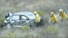  ?? Dan Watson/The Signal ?? Emergency response crews work to get a body out of a ravine on Wednesday. A California Highway Patrol officer said that hikers went down in the ravine and found a vehicle with a body inside. Officers confirmed that the motorist was pronounced dead on arrival.