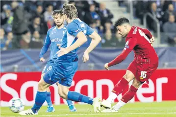  ?? AFP ?? Liverpool’s Alex Oxlade-Chamberlai­n, right, scores against Genk during their Uefa Champions League Group E game.