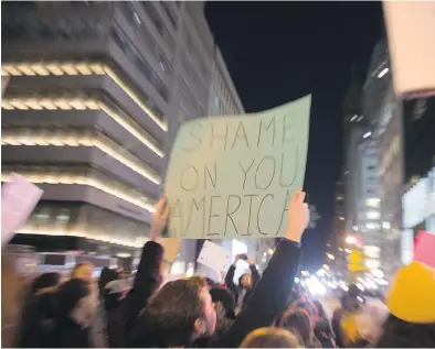  ?? BRYAN R. SMITH/AFP/GETTY IMAGES ?? Demonstrat­ors protest against president-elect Donald Trump outside Trump Tower in New York.