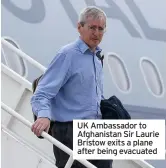  ??  ?? UK Ambassador to Afghanista­n Sir Laurie Bristow exits a plane after being evacuated