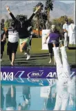  ?? Alex Gallardo ?? The Associated Press Pernilla Lindberg jumps into the pond with her parents and caddie/fiance Daniel Taylor, right, after winning the ANA Inspiratio­n on Monday at Rancho Mirage, Calif.