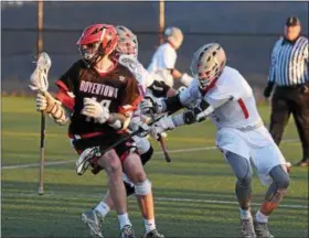  ?? AUSTIN HERTZOG - DIGITAL FIRST MEDIA ?? Boyertown’s Skylar Wallace spins out of pressure from Owen J. Roberts after winning a faceoff.