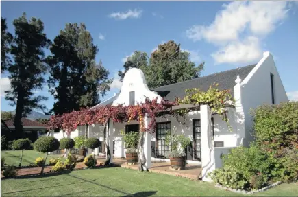  ??  ?? GRACIOUS LIVING: This 1975 three-bedroom Cape Dutch-style home in Morningsid­e, Somerset West, is on sale for R1.85 million.