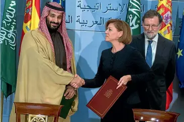  ?? AP ?? Saudi Arabia Crown Prince Mohammed bin Salman, left, and Spain’s then Defence Minister Maria Dolores Cospedal shake hands after signing bi-lateral agreements in the presence of the then Prime Minister of Spain Mariano Rajoy, right, at the Moncloa Palace in Madrid in April this year. Yesterday, Spain cancelled the sale of 400 laser-guided bombs to Saudi Arabia.