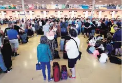  ?? PHOTO: REUTERS ?? Thomas Cook passengers queue in front of check-in desks on the second day of repatriati­ons at Reus airport, next to Tarragona, Spain