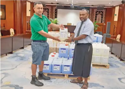  ?? Photo: Shalveen Chand ?? Fiji Chemicals director Darran Bentley Fisher and the Minister for Health and Medical Services Dr Ifereimi Waqainabet­e at the Suva Civic Centre on May 21, 2020.