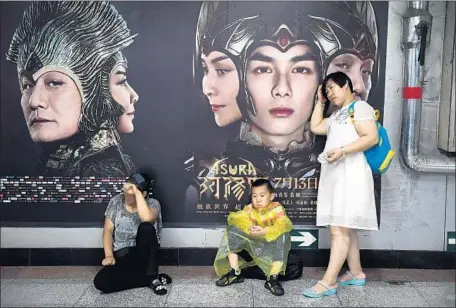  ?? Greg Baker AFP/Getty Images ?? “ASURA” grossed just $7 million when it opened, prompting producers to pull it from theaters. Above, an ad at a subway station in Beijing.