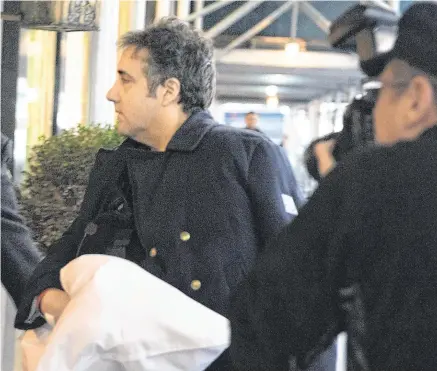  ?? PHOTO: KEVIN HAGEN/AP PHOTO/ ?? Evidence: Michael Cohen arrives at his home in New York following surgery on his shoulder.