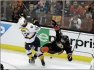  ?? THE ASSOCIATED PRESS ?? Nashville’s Matt Irwin (52) collides with Anaheim’s Chris Wagner (21) as they battle for the puck during the second period of Game 2 of the Western Conference finals Sunday in Anaheim, Calif.