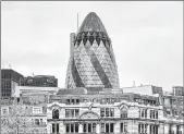  ?? DREAMSTIME ?? The Swiss Re tower in London. Swiss Re said COVID-19 cost it almost $2 billion in the first half of 2020 alone.