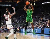  ?? JOE SARGENT - GETTY IMAGES ?? Jermaine Couisnard of Oregon shoots against Myles Stute of South Carolina in Thursday’s NCAA Tournament opener.
