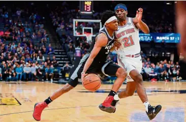  ?? — Reuters ?? Eyes on the basket: Sacramento Kings guard De’Aaron Fox (left) in action against New York Knicks guard Damyean Dotson during the NBA game at the Golden 1 Centre on Monday.