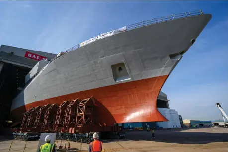  ??  ?? HMS Glasgow – shown under constructi­on, below-left – rolled out from the buildhall under blue skies at the River Clyde; below, a graphic showing the City Class Type 26 frigate being