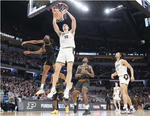  ?? ANDY LYONS/GETTY IMAGES ?? Purdue giant Zach Edey throws down a dunk against Grambling State. He dominated with 30 points on 11-for-17 shooting and 21 rebounds in 30 minutes.