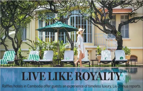  ??  ?? A guest passes by a swimming pool at the Raffles Hotel Le Royal in the heart of Phnom Penh, Cambodia.