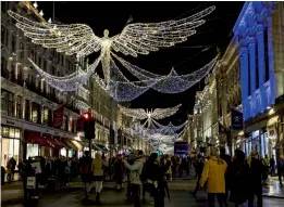  ??  ?? Passersby enjoy the Christmas light decoration­s with the theme of “The Spirit of Christmas” on Regent Street in central London on Thursday, as the British capital gears up for the festive season. Since 1954 the lights of Regents Street have been...