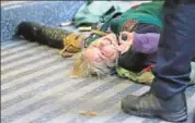  ??  ?? A climate activist lies on the floor during a rally in London.
AFP