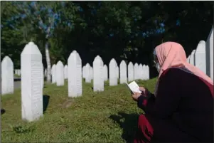  ?? The Associated Press ?? BOSNIA: A woman prays in Potocari, near Srebrenica, Bosnia, on Saturday. Nine newly found and identified men and boys were laid to rest as Bosnians commemorat­e 25 years since more than 8,000 Bosnian Muslims perished in 10 days of slaughter, after Srebrenica was overrun by Bosnian Serb forces during the closing months of the country’s 1992-95 fratricida­l war, in Europe’s worst postWWII massacre.