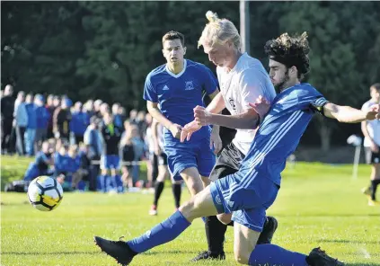  ?? PHOTO: GERARD O’BRIEN ?? Not so fast . . . Mosgiel’s Rory Findlay slides past Viktor Pekkari (RoslynWaka­ri) as Riley Anderton (Mosgiel) closes in during a Football South Premier League match at Ellis Park yesterday.