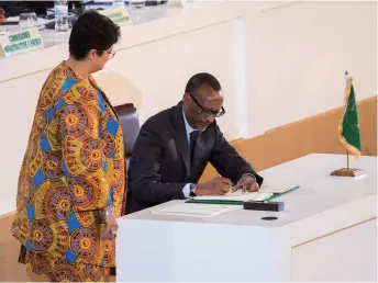  ??  ?? Rwandan President Paul Kagame, Chairperso­n of the African Union, signs the African Free Trade Zone agreement to promote regional economic integratio­n on March 21 in Kigali, the Rwandan capital