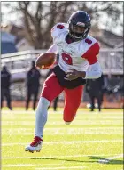  ?? TIMOTHY ARRICK — FOR MEDIANEWS GROUP ?? Oak Park’s James Burnley carries the ball in first-half action of the Knights’ 3023 victory over Livonia Churchill in MHSAA regional final action on Saturday in Livonia.