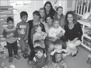  ?? Photo by Joseph B. Nadeau ?? Gov. Gina Raimondo and Mayor Lisa Baldelli-Hunt, right, pose for a photo with the children and childcare workers at Highland Park Children’s Center.