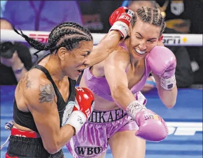  ?? John Locher The Associated Press ?? Mikaela Mayer, right, trades punches Erica Farias in a WBO title fight in June in Las Vegas.