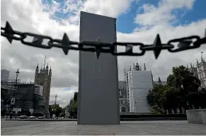  ?? GETTY IMAGES ?? A protected statue of Sir Winston Churchill in Parliament Square. Several statues and monuments were protected with scaffoldin­g ahead of the weekend’s protests.