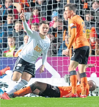  ?? Pictures: SNS. ?? Above: Lawrence Shankland wheels away after giving Ayr an early lead; left: the former Aberdeen striker celebrates doubling the Honest Men’s lead just before half-time.