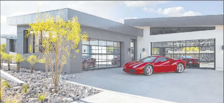  ?? Sun West Custom Homes ?? The 2019 New American Home displayed at by the National Associatio­n of Home Builders’ show in Las Vegas in February features a luxury garage.