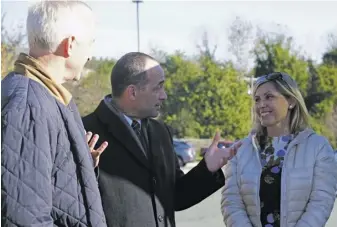  ?? PHOTOS BY RACHEL NEEDHAM ?? Republican congressio­nal candidate Bob Good, above, engages two Albemarle County supporters who turned out to vote at StoneRobin­son Elementary School outside Charlottes­ville early Tuesday morning.