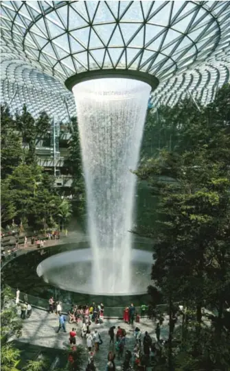  ?? ?? The Rain Vortex at Jewel Changi Airport. With water cascading down 40 metres, it is the world’s tallest indoor waterfall. Photo by Jansen Yang, 8 October 2019. Retrieved from Unsplash.