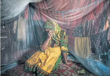  ??  ?? DESPAIR: Rahima Khatun, 21, who grew up in a refugee camp, is forced to work as a prostitute. ‘I’m doing all this for my son,’ she said.